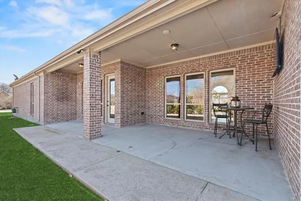 a view of a porch with chairs and backyard