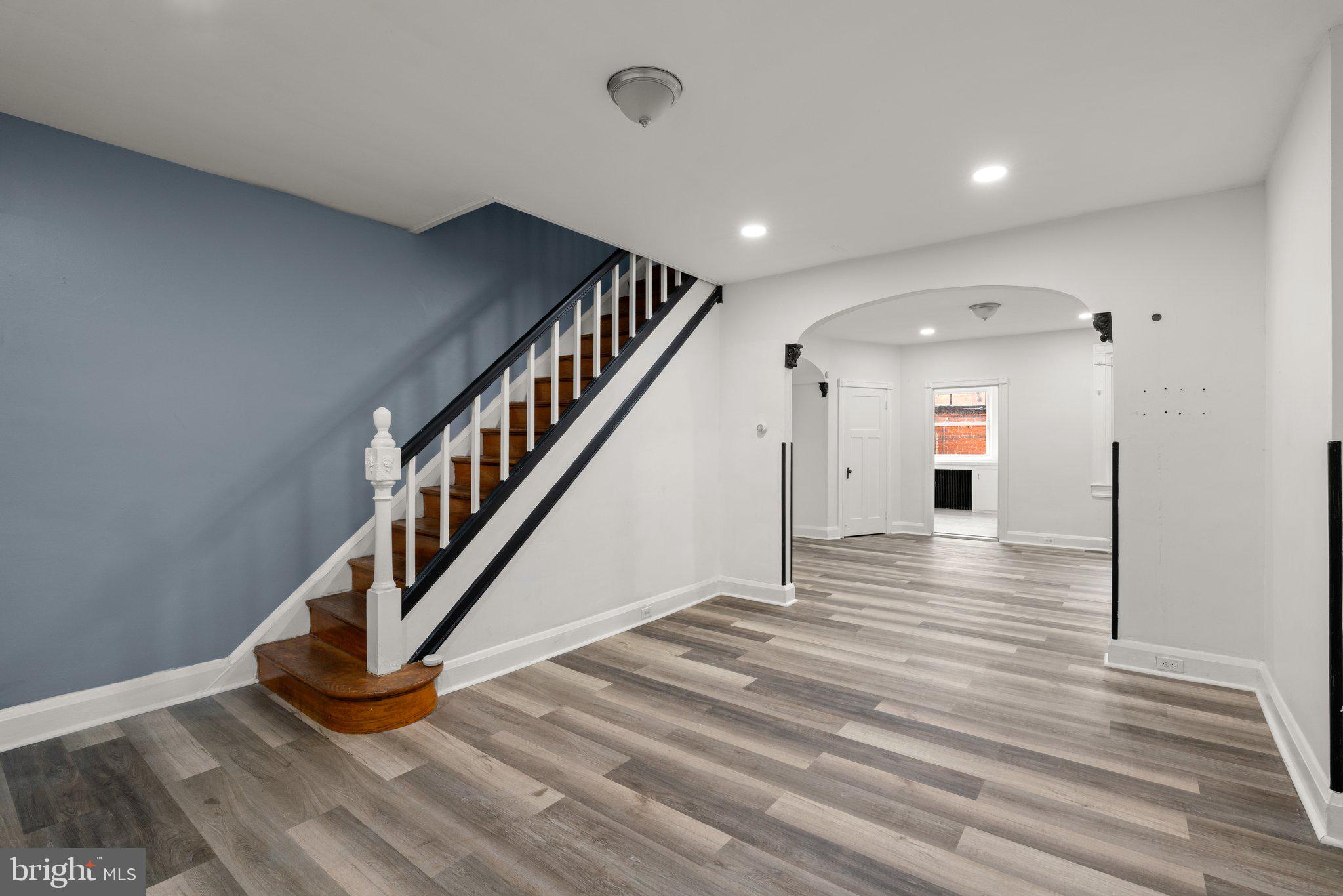 a view of entryway and hall with wooden floor