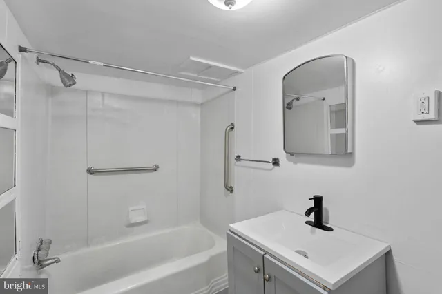 a bathroom with a sink a mirror and a bathtub