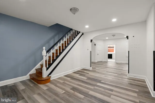 a view of entryway and hall with wooden floor