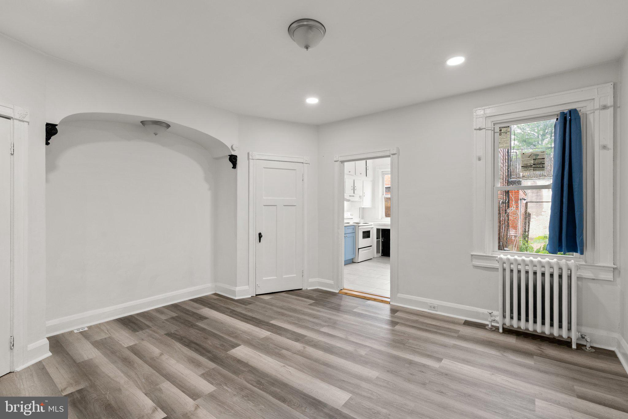4208 Sheldon Avenue Baltimore, MD 21206 - Photo 7 of 26 a view of a hallway with wooden floor and windows