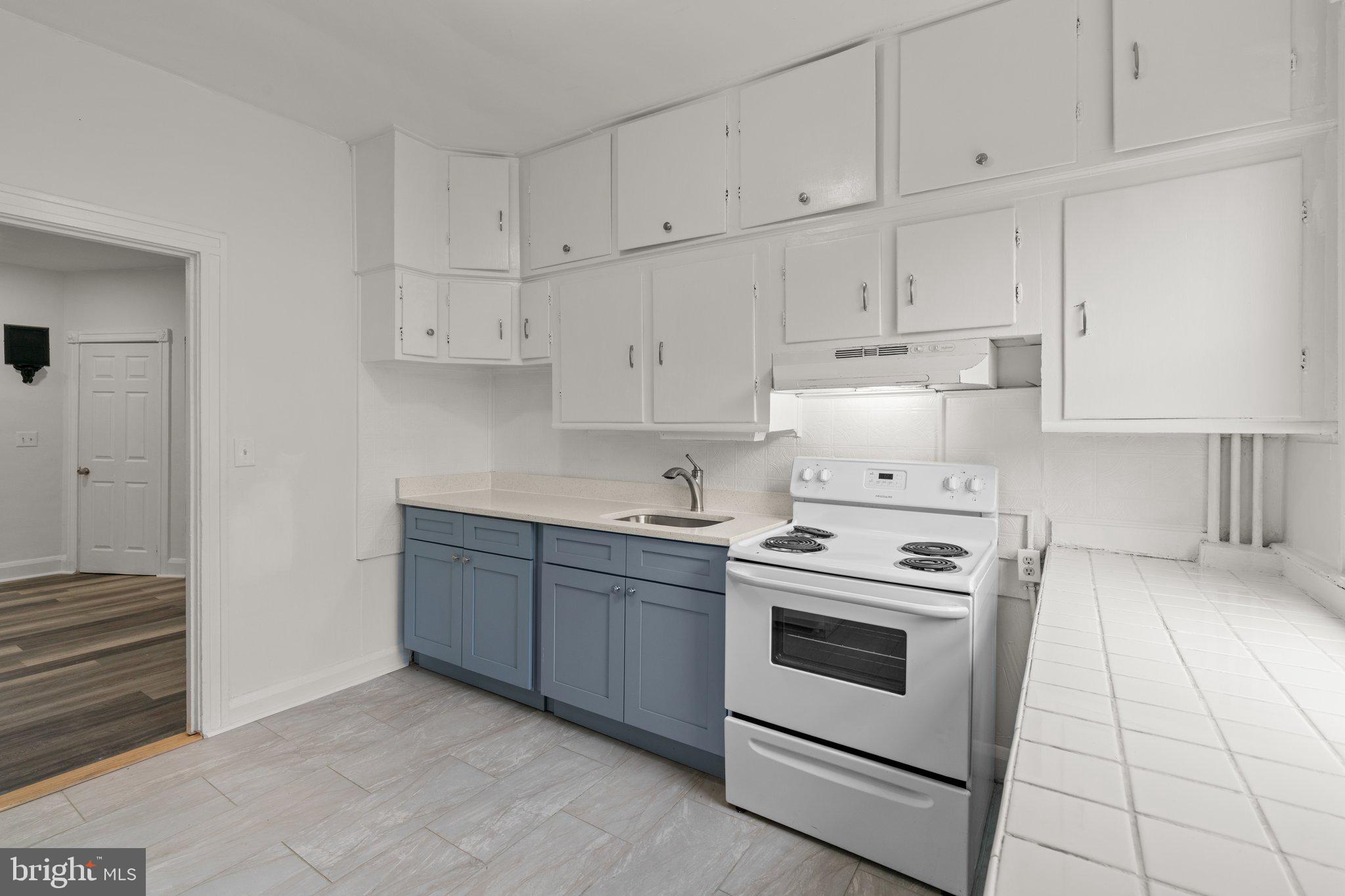 4208 Sheldon Avenue Baltimore, MD 21206 - Photo 9 of 26 a kitchen with granite countertop white cabinets and white appliances