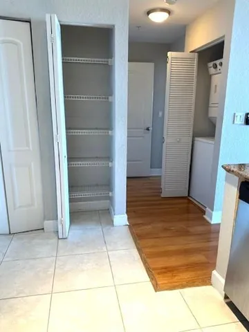 a view of walk in closet with empty racks