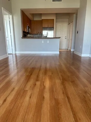 a view of a living room barbecue kitchen and wooden floor