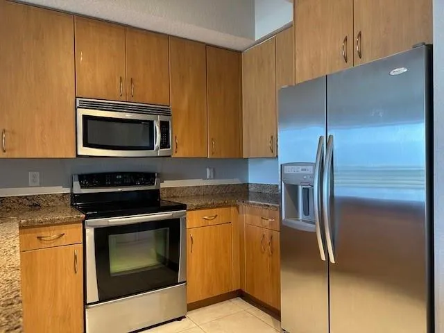 a kitchen with a refrigerator stove and microwave
