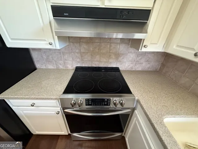 a kitchen with stainless steel appliances a sink and cabinets