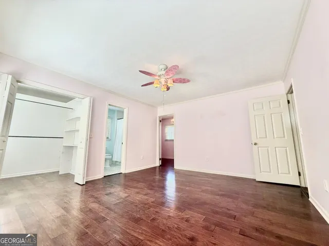 a view of a room with wooden floor