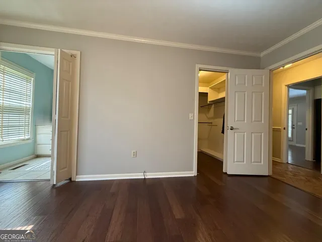 a bathroom with a double vanity sink a toilet and a mirror