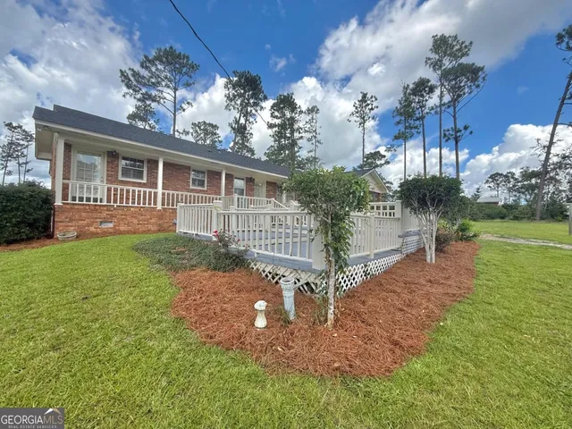 a front view of a house with a yard and porch