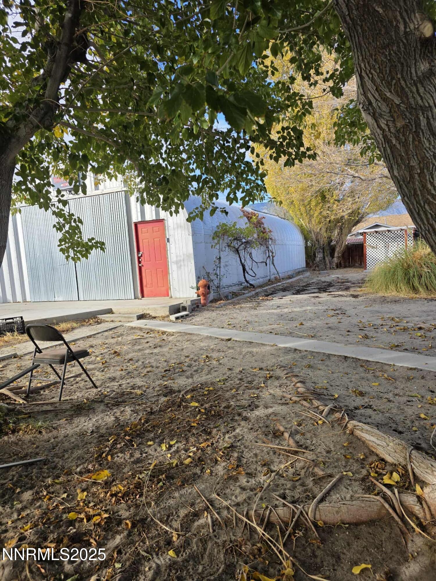 363 F Street Hawthorne, NV 89415 - Photo 6 of 6 a view of backyard with large tree and wooden fence