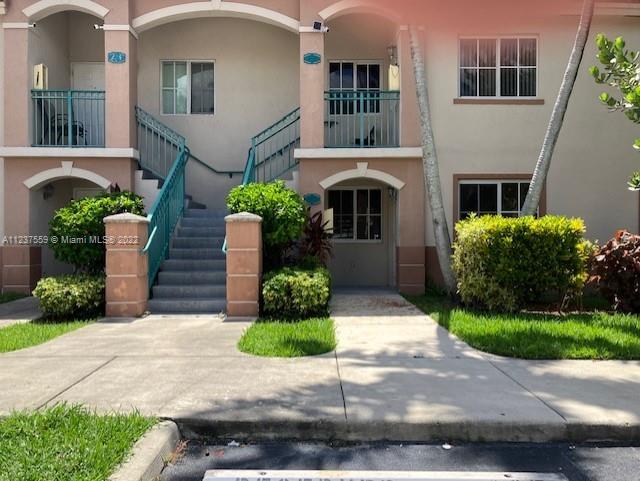 2910 Southeast 13th Road, Unit 10544 Homestead, FL 33035 - Photo 6 of 7 a front view of a house with garden