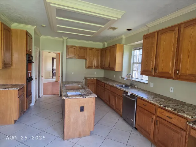 a kitchen with stainless steel appliances granite countertop wooden cabinets a sink and dishwasher
