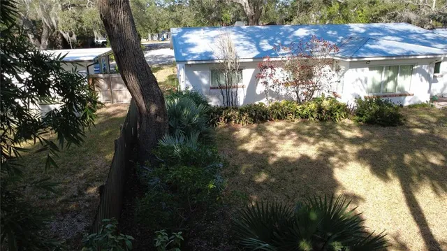 a view of backyard of house with green space