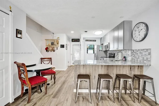 a view of a dining room with furniture and a clock