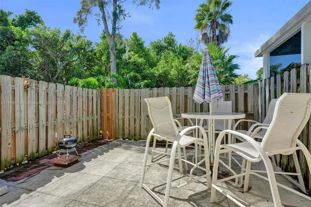 a view of a chairs and table in patio