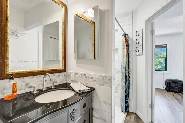 a bathroom with a sink double vanity and a mirror