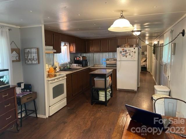 2363 Coley Pond Road Newton, NC 28658 - Photo 6 of 17 a kitchen with a refrigerator a stove cabinets and wooden floor
