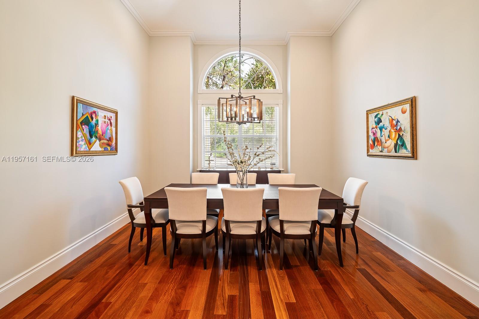 5770 Southwest 128th Street Pinecrest, FL 33156 - Photo 15 of 37 a dining room with furniture a rug and wooden floor