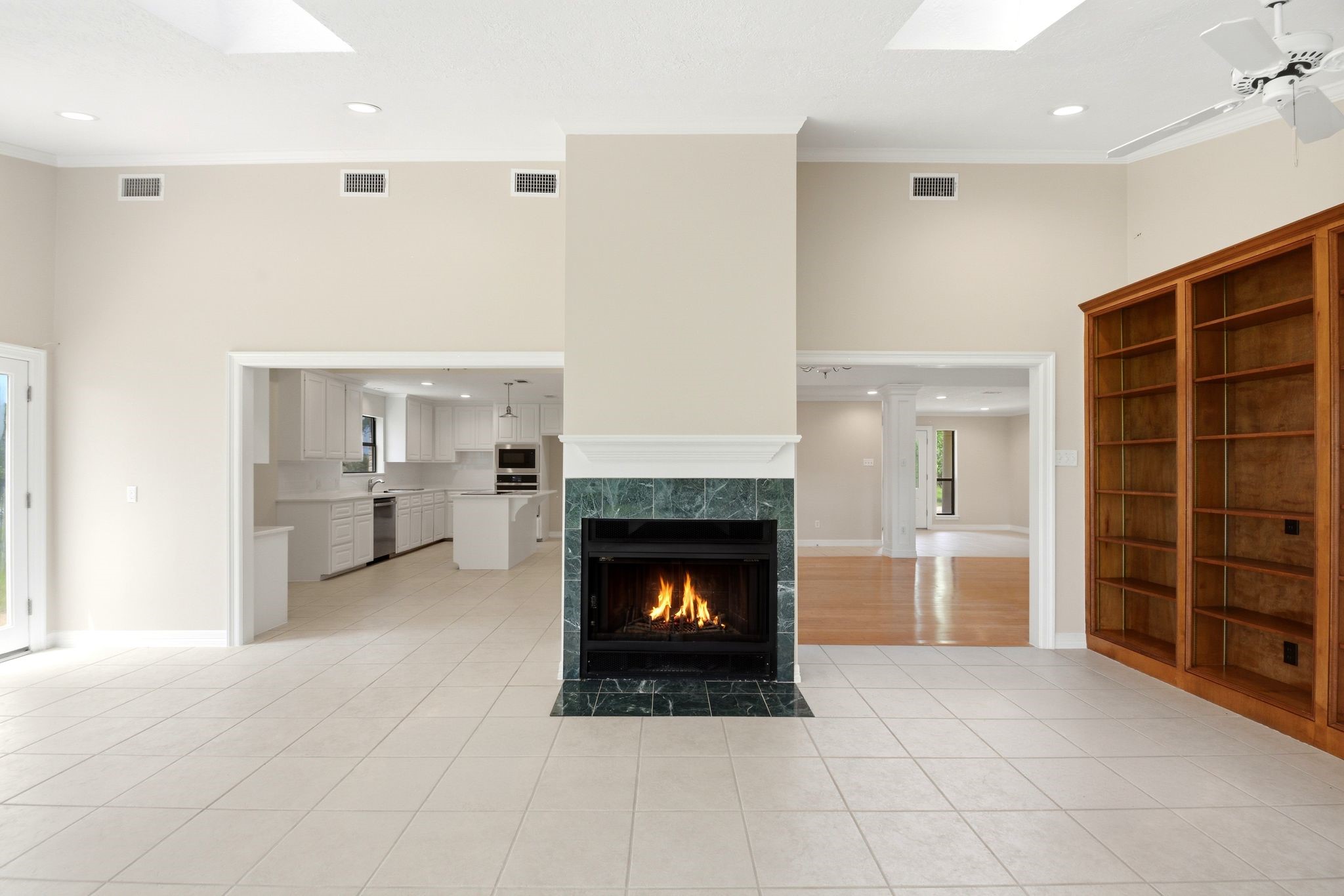 22509 Pebble Beach Way Point Blank, TX 77364 - Photo 7 of 30 High-ceiling family room with fireplace and built-in shelving