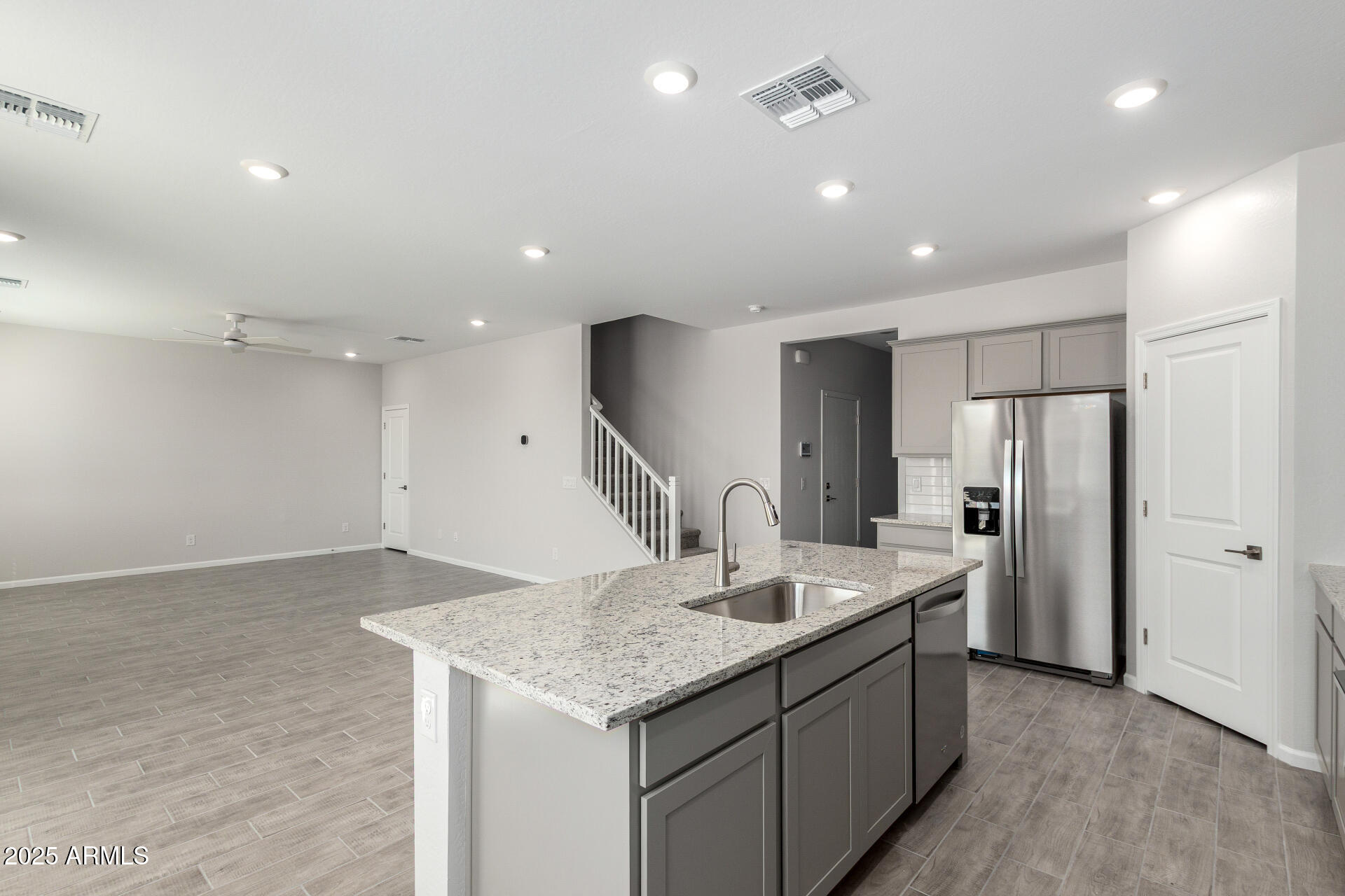 18207 West Daley Lane Surprise, AZ 85387 - Photo 15 of 40 a kitchen with stainless steel appliances granite countertop a sink and a refrigerator