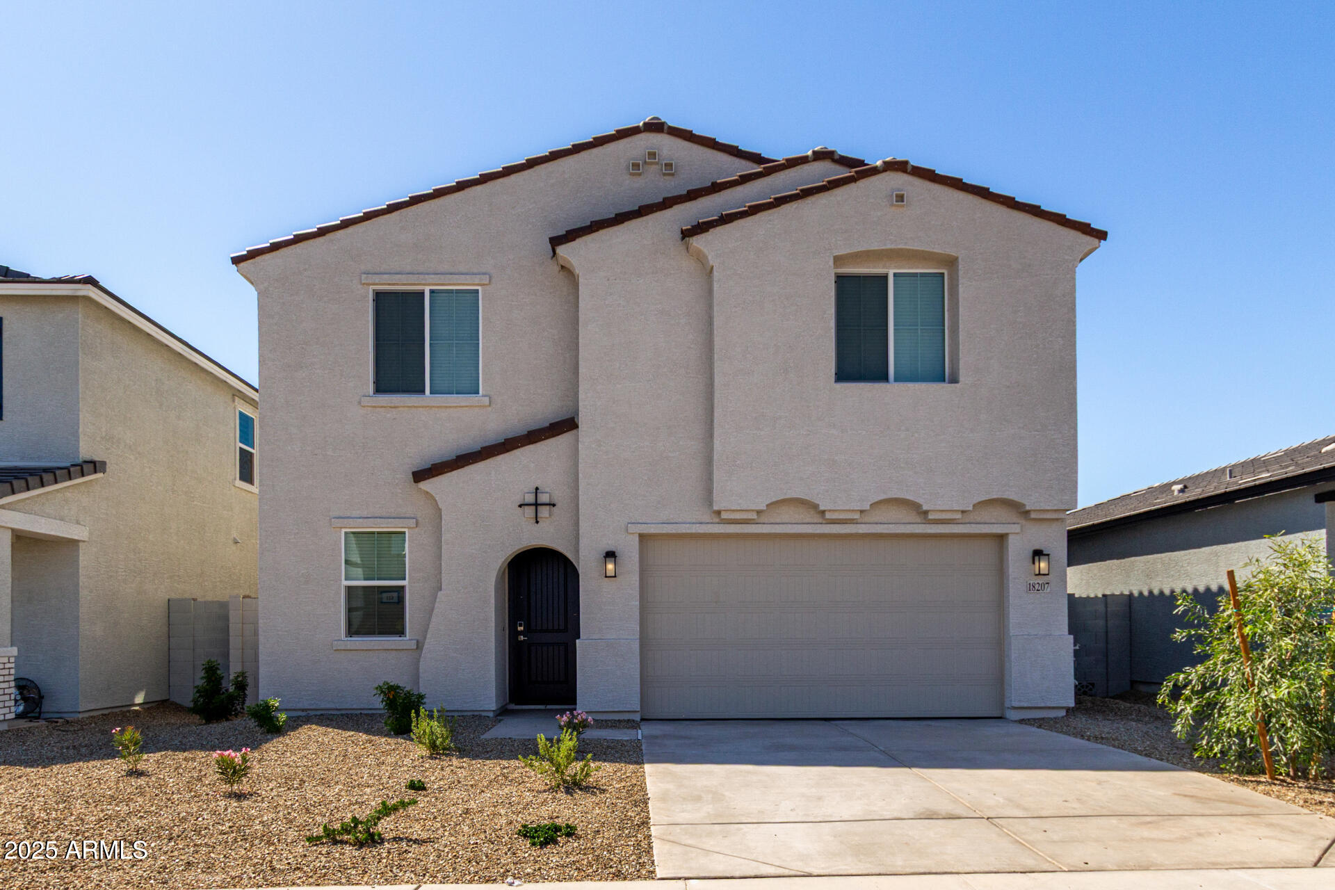 18207 West Daley Lane Surprise, AZ 85387 - Photo 2 of 40 a front view of a house with a yard