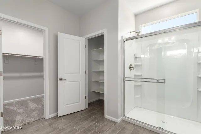 a bathroom with a glass shower door