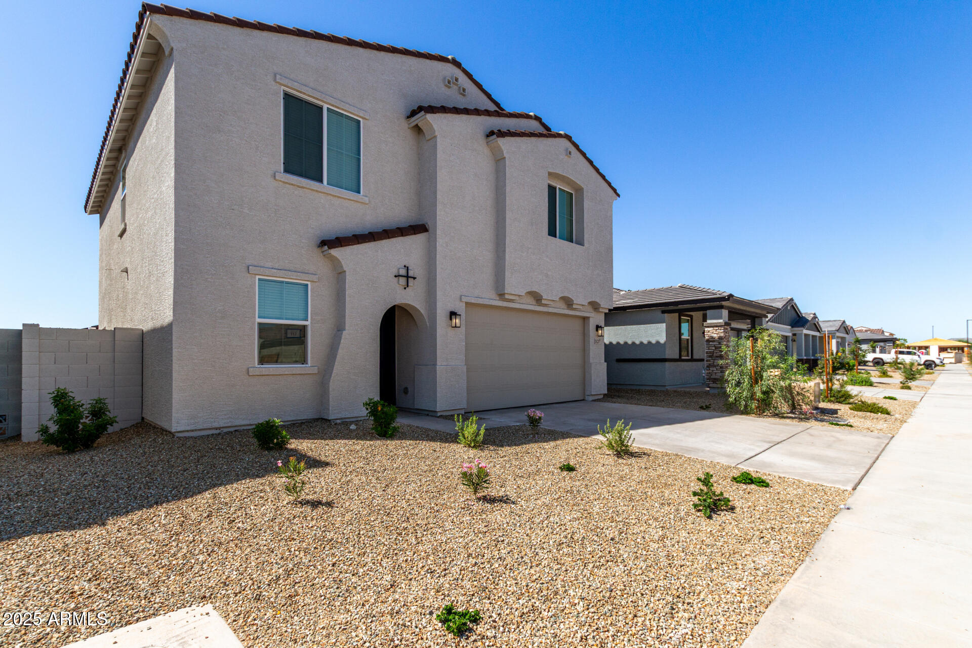 18207 West Daley Lane Surprise, AZ 85387 - Photo 3 of 40 a view of a white house with large windows