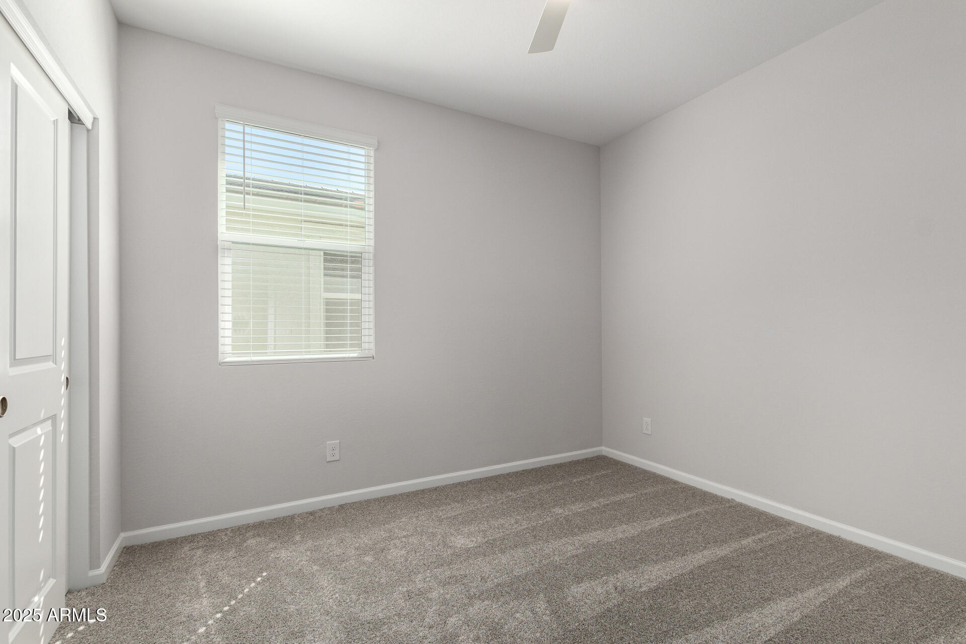 18207 West Daley Lane Surprise, AZ 85387 - Photo 31 of 40 an empty room with a window