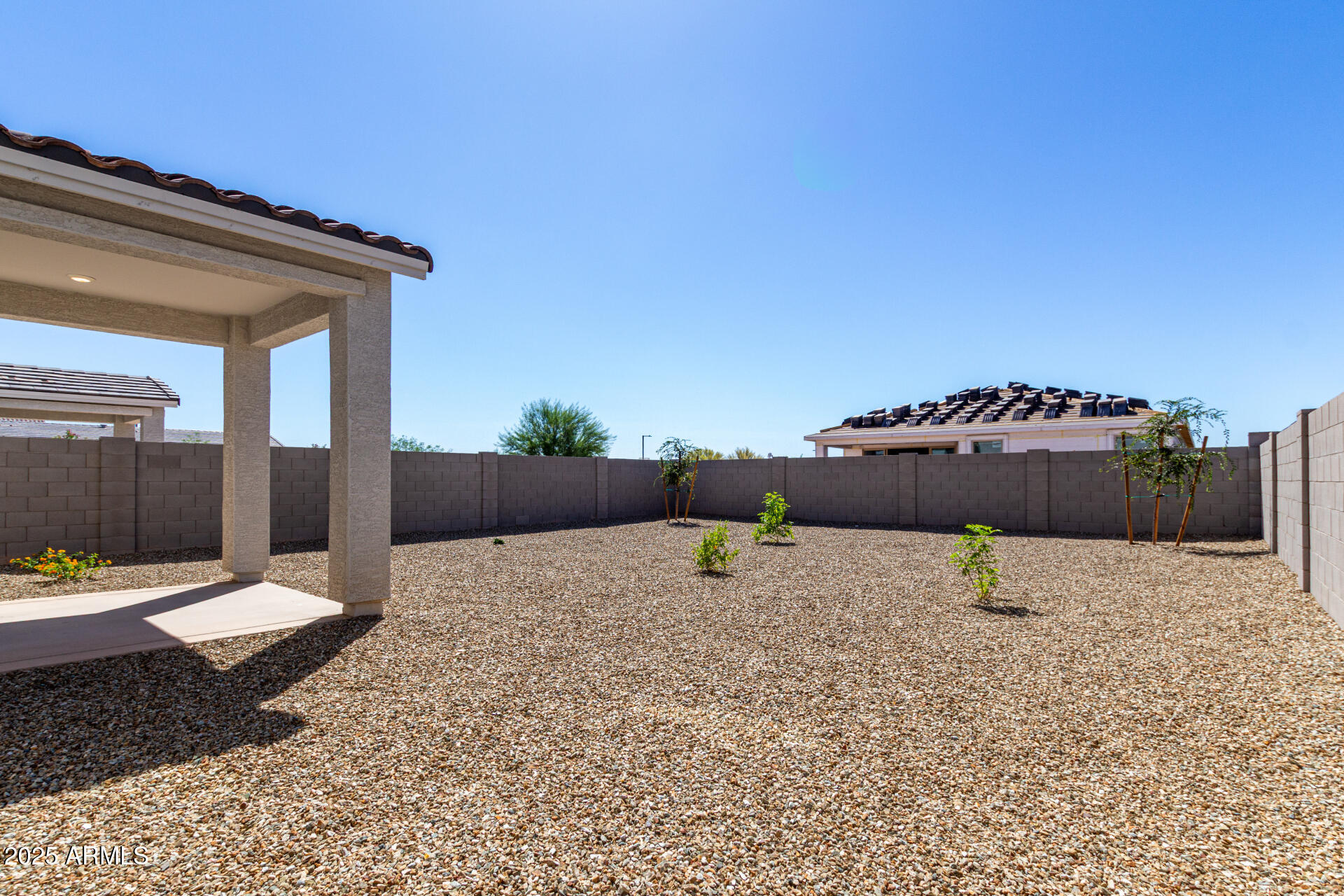 18207 West Daley Lane Surprise, AZ 85387 - Photo 36 of 40 a backyard of a house with table and chairs