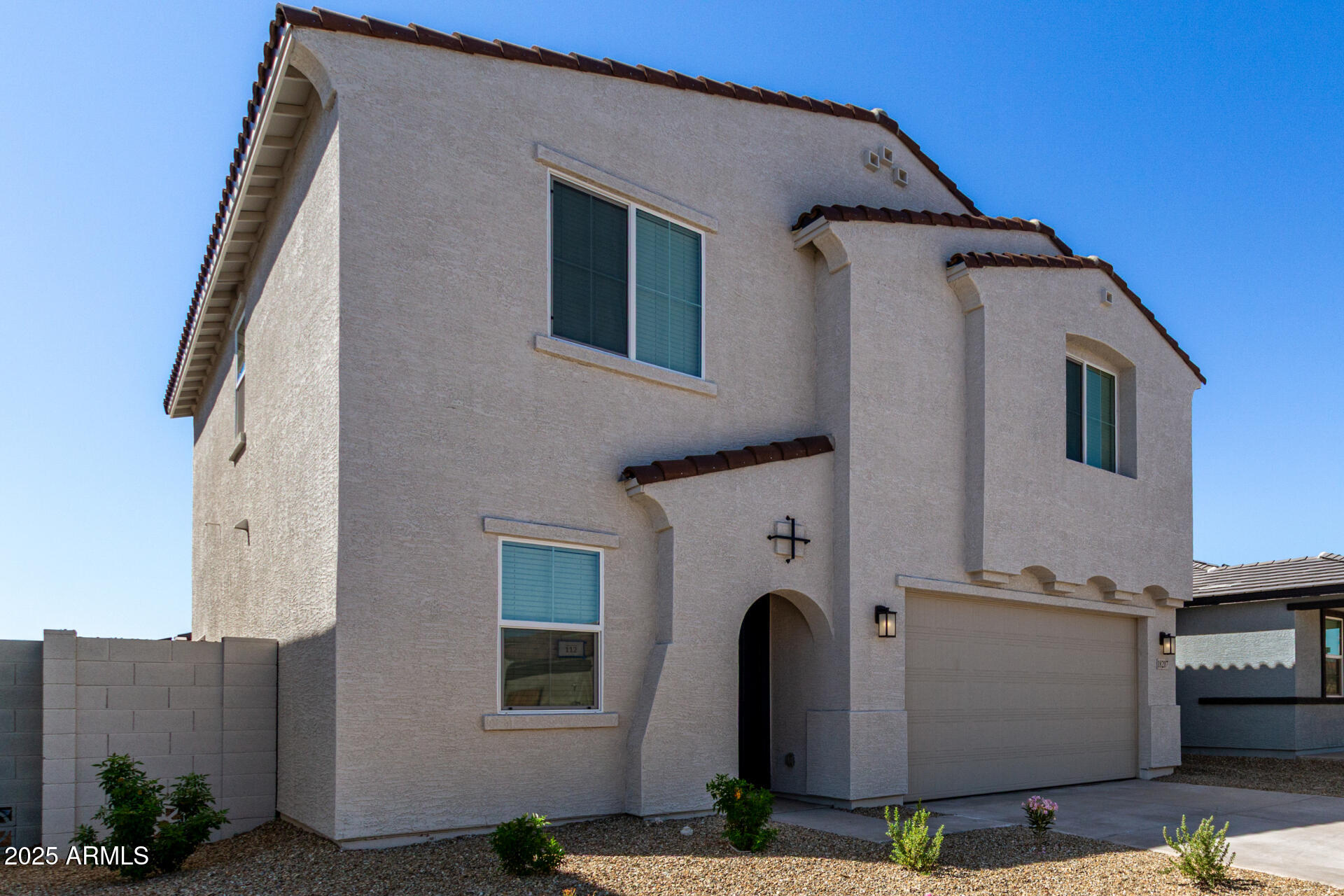18207 West Daley Lane Surprise, AZ 85387 - Photo 4 of 40 a front view of a house with garden