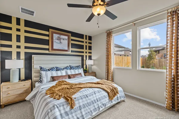 a bedroom with a large bed and a chandelier