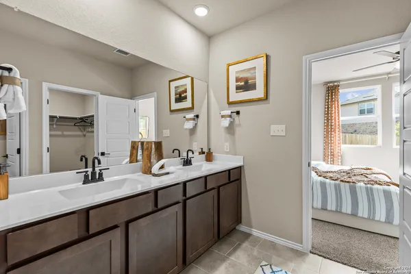 a bathroom with 2 sink tub and a mirror