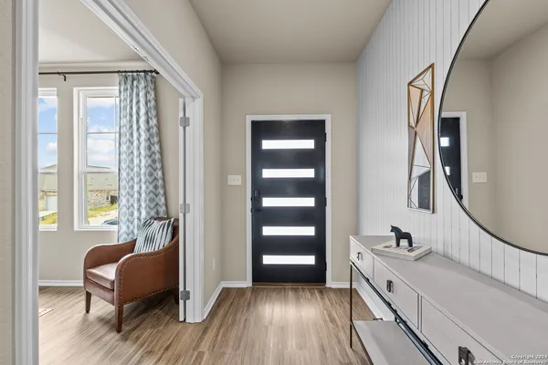 a spacious bedroom with a bed and a mirror