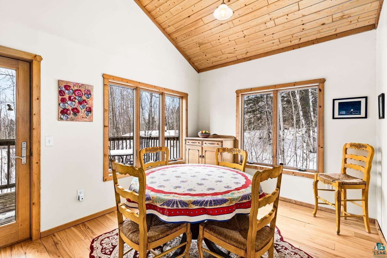 67 Snowshoe Trail Tofte, MN 55615 - Photo 20 of 42 Dining room with a vaulted wood ceiling and light wood-type flooring