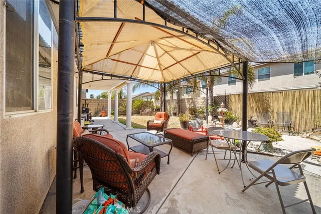 a view of a patio with table and chairs potted plants with wooden floor