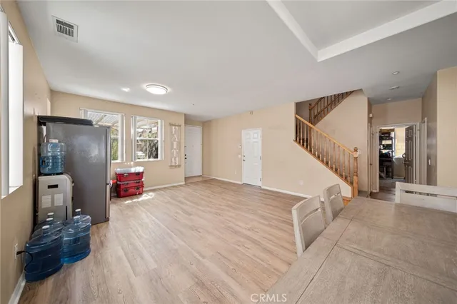 a view of a livingroom with wooden floor and furniture