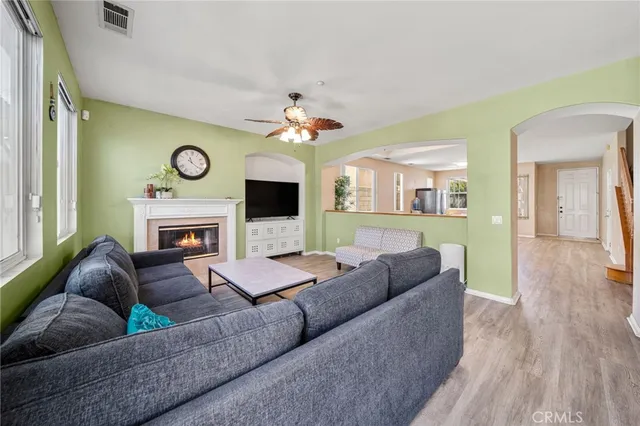 a living room with furniture a fireplace and a window
