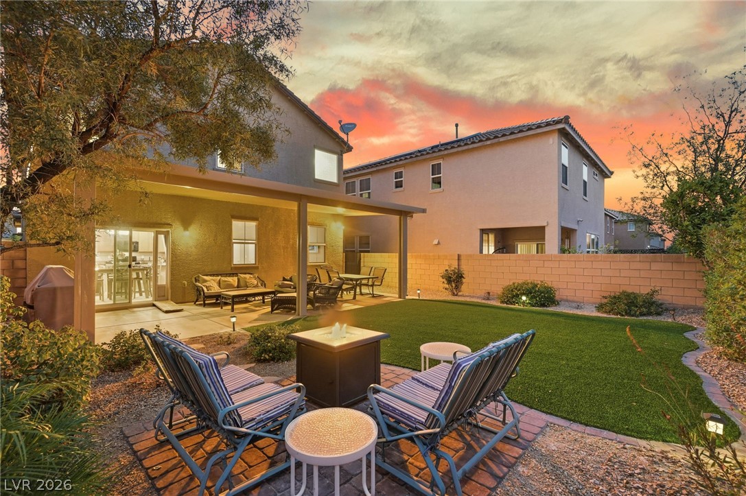 150 Fulgora Street Henderson, NV 89074 - Photo 11 of 92 Rear view of house featuring a patio, stucco siding, a fenced backyard, and outdoor seating