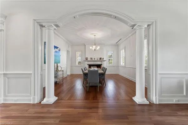 a living room with furniture kitchen area and a window