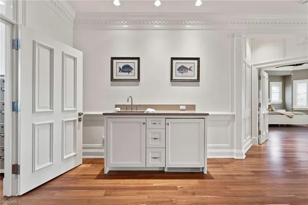 a view of kitchen with cabinets and wooden floor