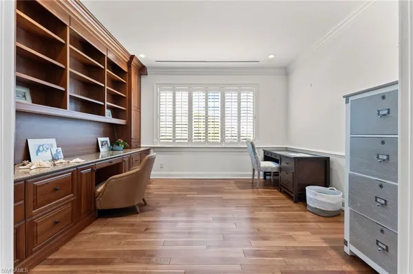 a view of a hallway with wooden floor and cabinet