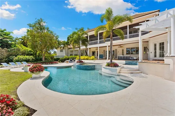 a view of a swimming pool and lounge chairs