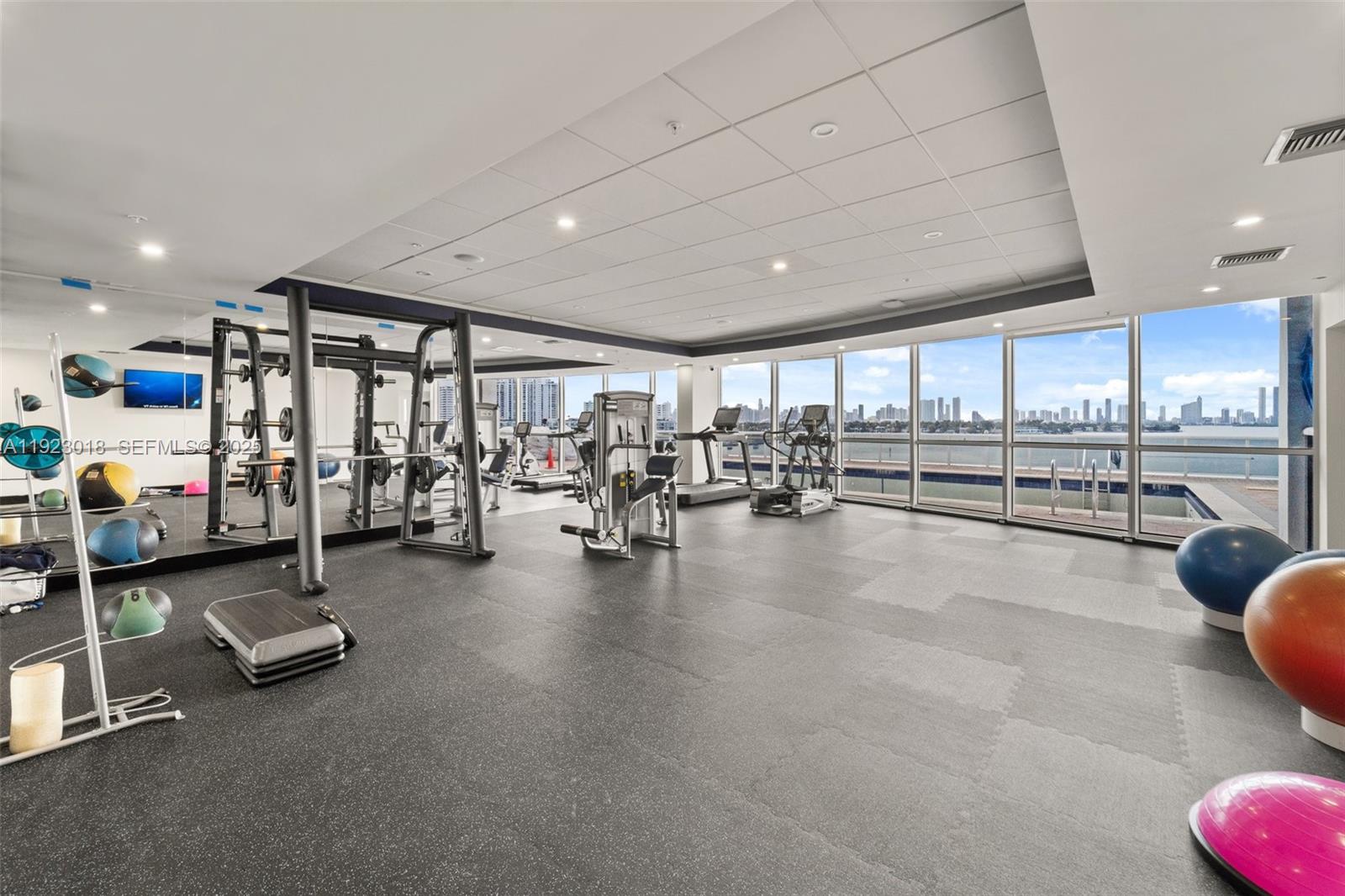 1900 Sunset Harbour Drive, Unit 2115 Miami Beach, FL 33139 - Photo 19 of 25 a gym room with lots of furniture and a large window