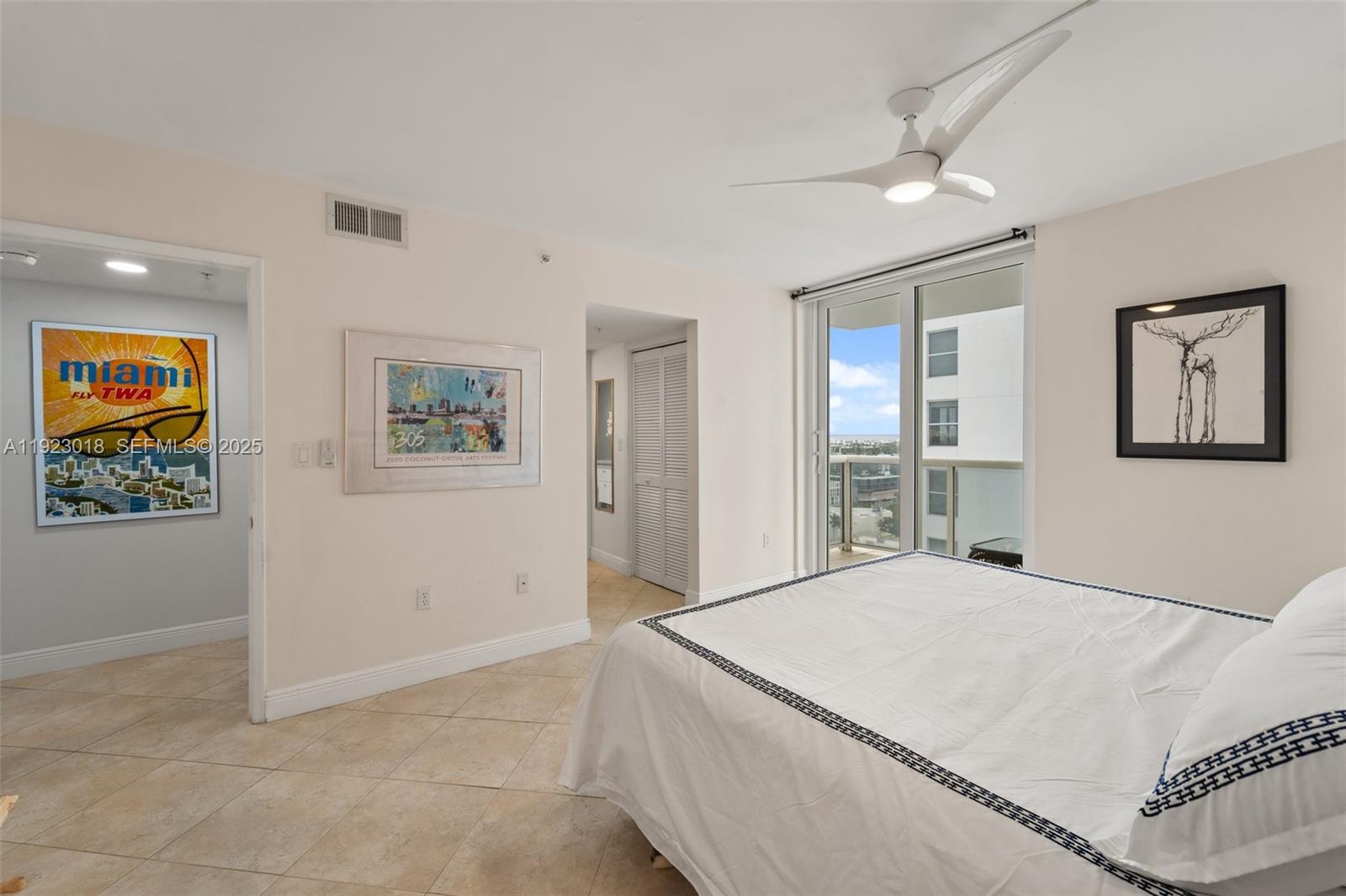 1900 Sunset Harbour Drive, Unit 2115 Miami Beach, FL 33139 - Photo 25 of 25 a bedroom with a large bed and a chandelier