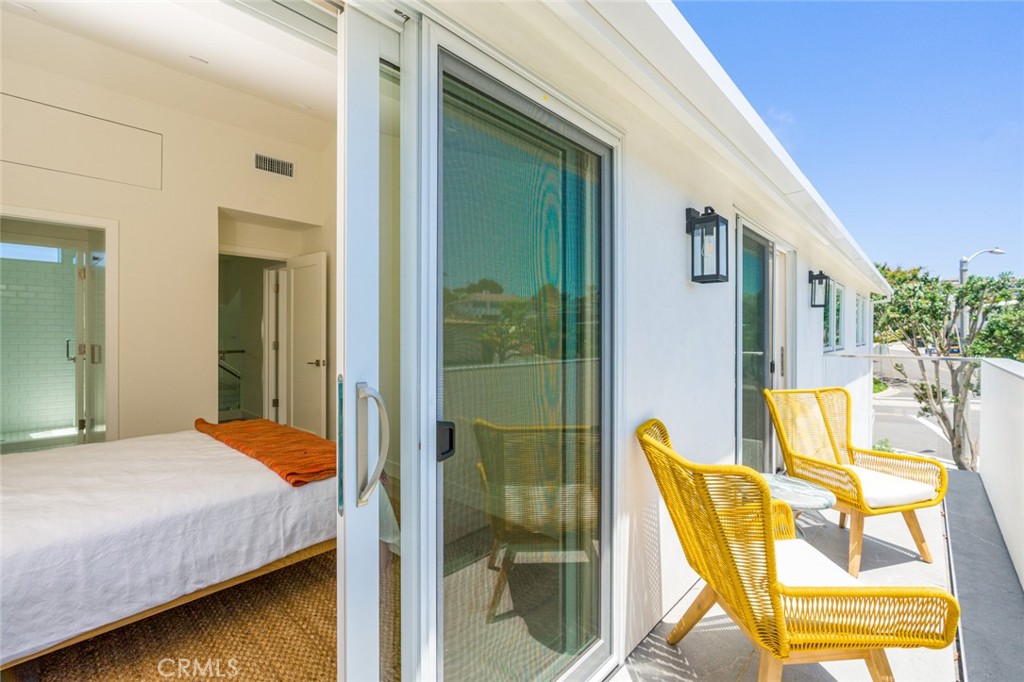 478 Morning Canyon Road Corona del Mar, CA 92625 - Photo 14 of 23 a bedroom with a bed and glass windows