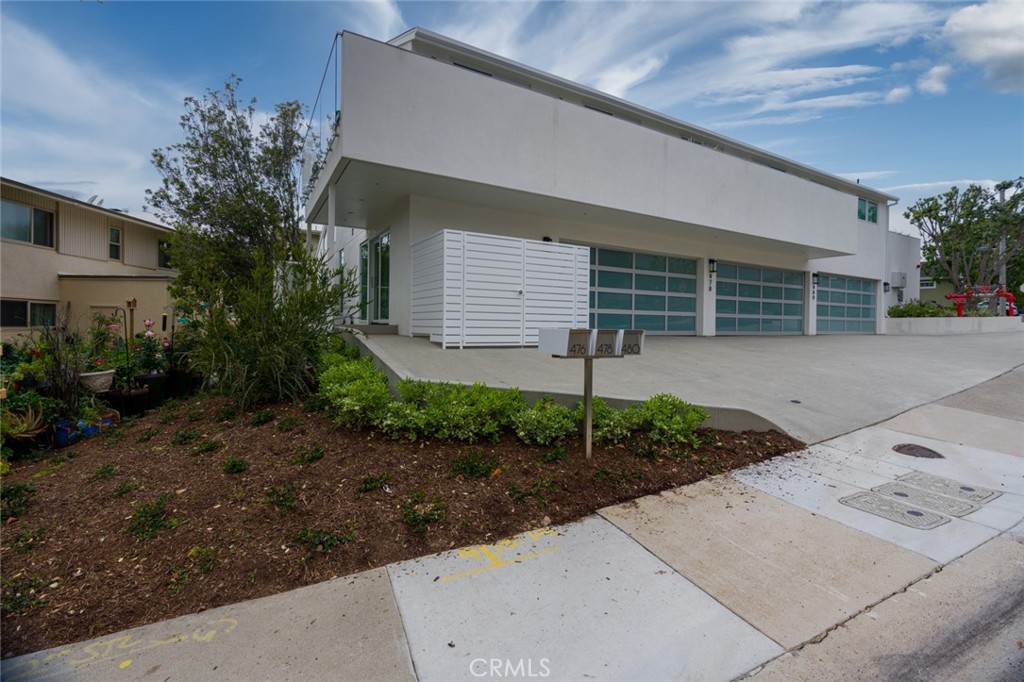 478 Morning Canyon Road Corona del Mar, CA 92625 - Photo 18 of 23 a front view of a house with garden and plants