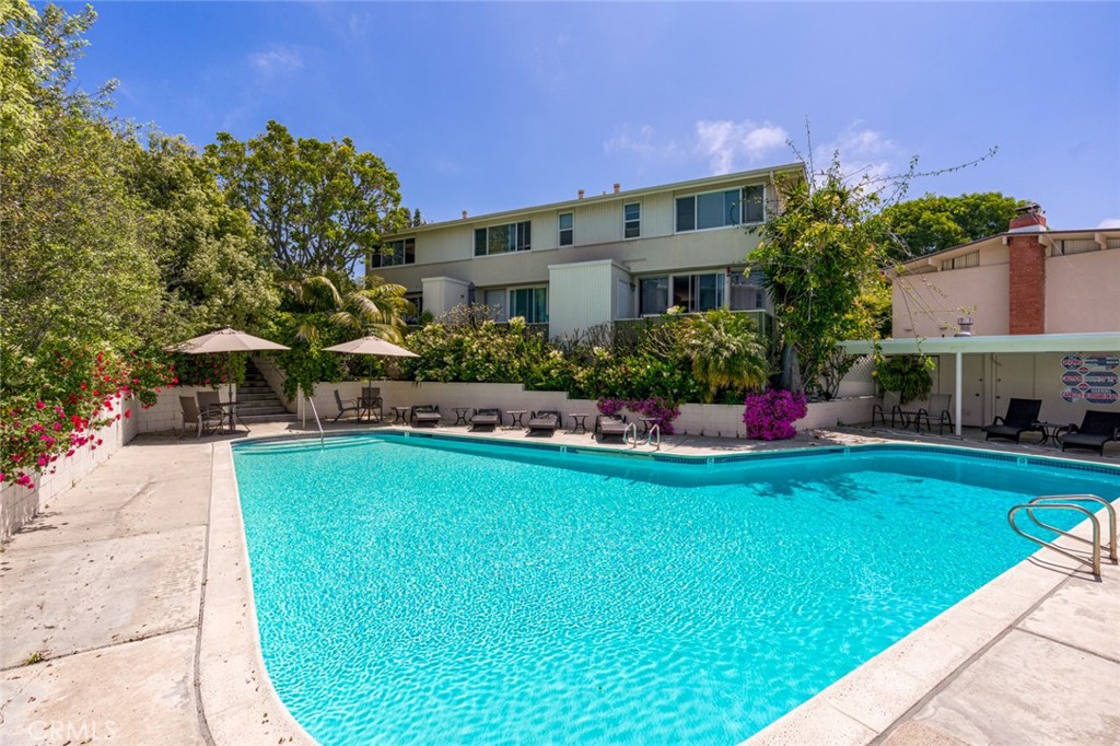 478 Morning Canyon Road Corona del Mar, CA 92625 - Photo 20 of 23 a front view of a house with a garden and plants