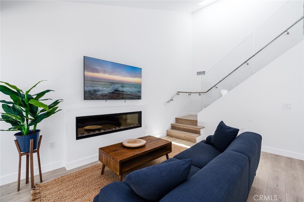 478 Morning Canyon Road Corona del Mar, CA 92625 - Photo 2 of 23 a living room with furniture a fireplace and a potted plant