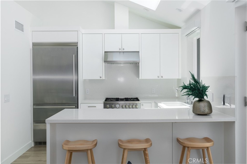 478 Morning Canyon Road Corona del Mar, CA 92625 - Photo 5 of 23 a kitchen with a potted plant on the counter and cabinets