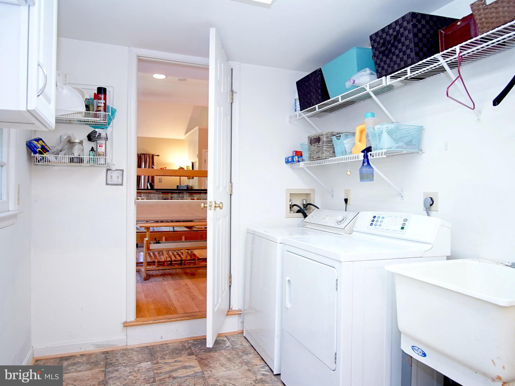 227 Midsummer Circle Gaithersburg, MD 20878 - Photo 21 of 25 a utility room with cabinets washer and dryer